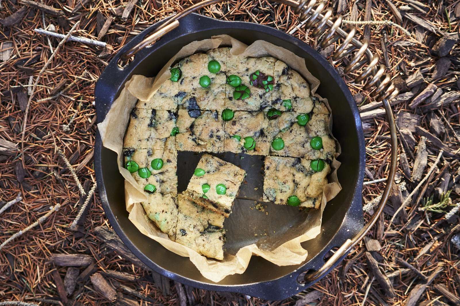chocolate chip cookie bars in the dutch oven outdoors