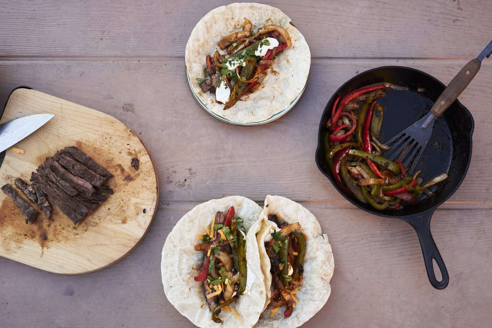 picnic table with grilled steak fajitas camping dinner