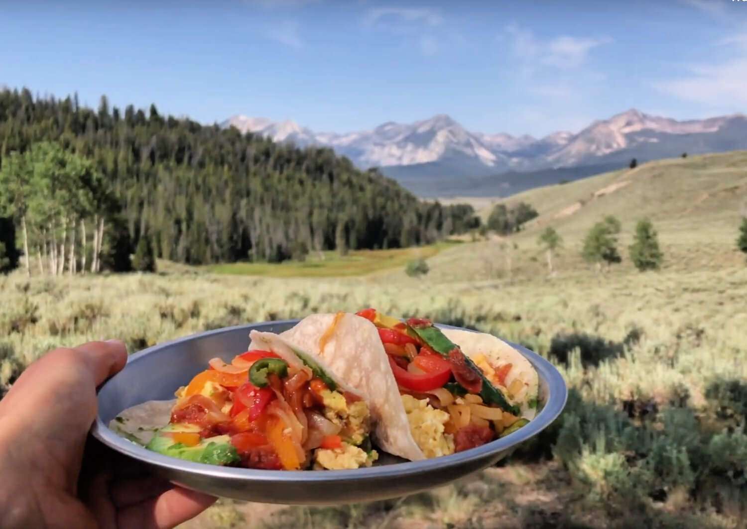 two breakfast tacos with scrambled eggs and peppers 