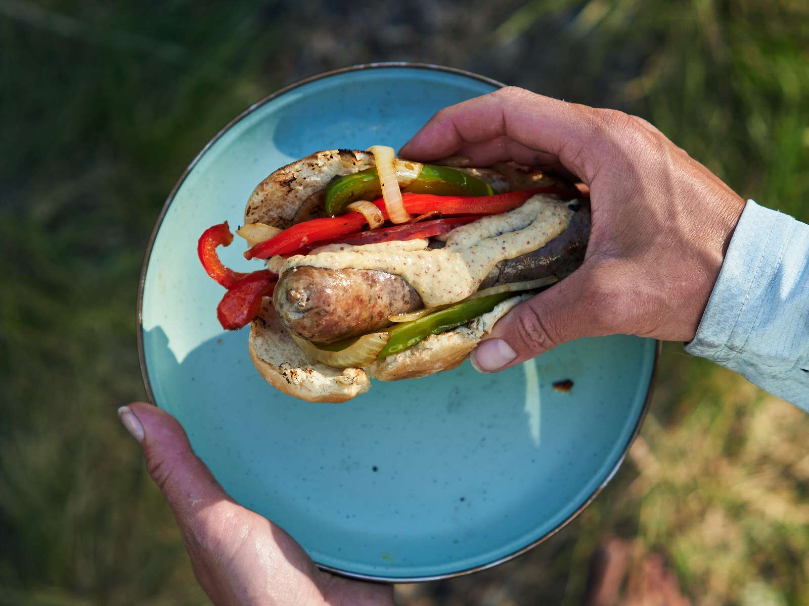 sausage, peppers, and onions in a hot dog bun for easy camping dinner 