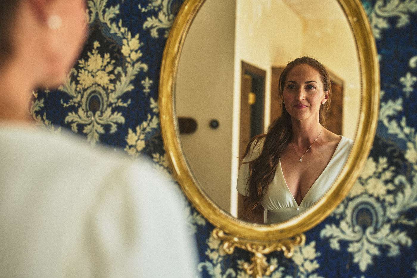 amanda looking in the mirror getting ready for her wedding day