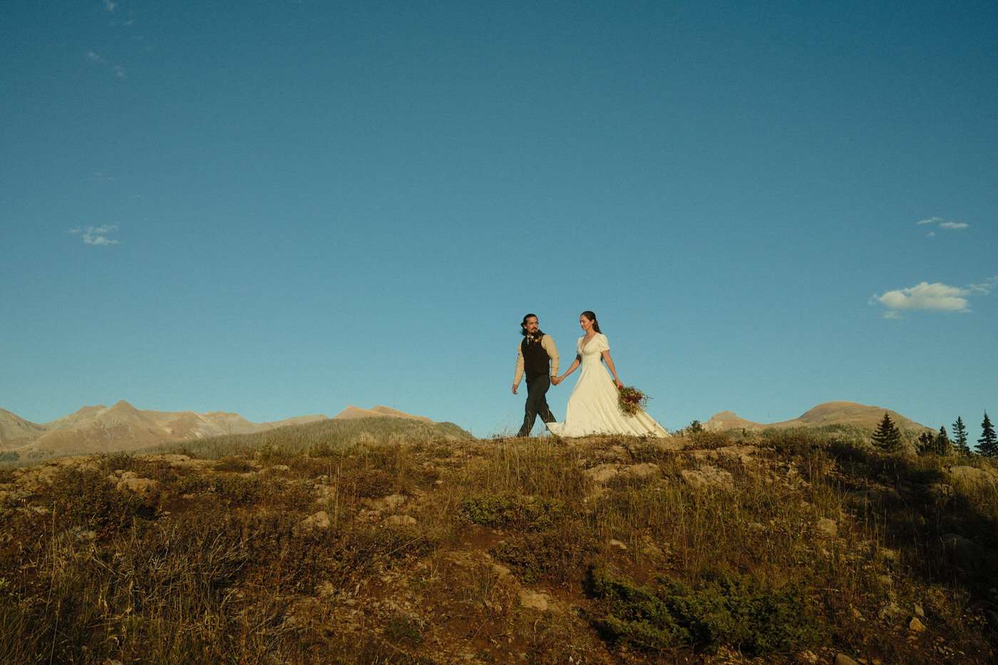 amanda and nick walking through the mountains 
