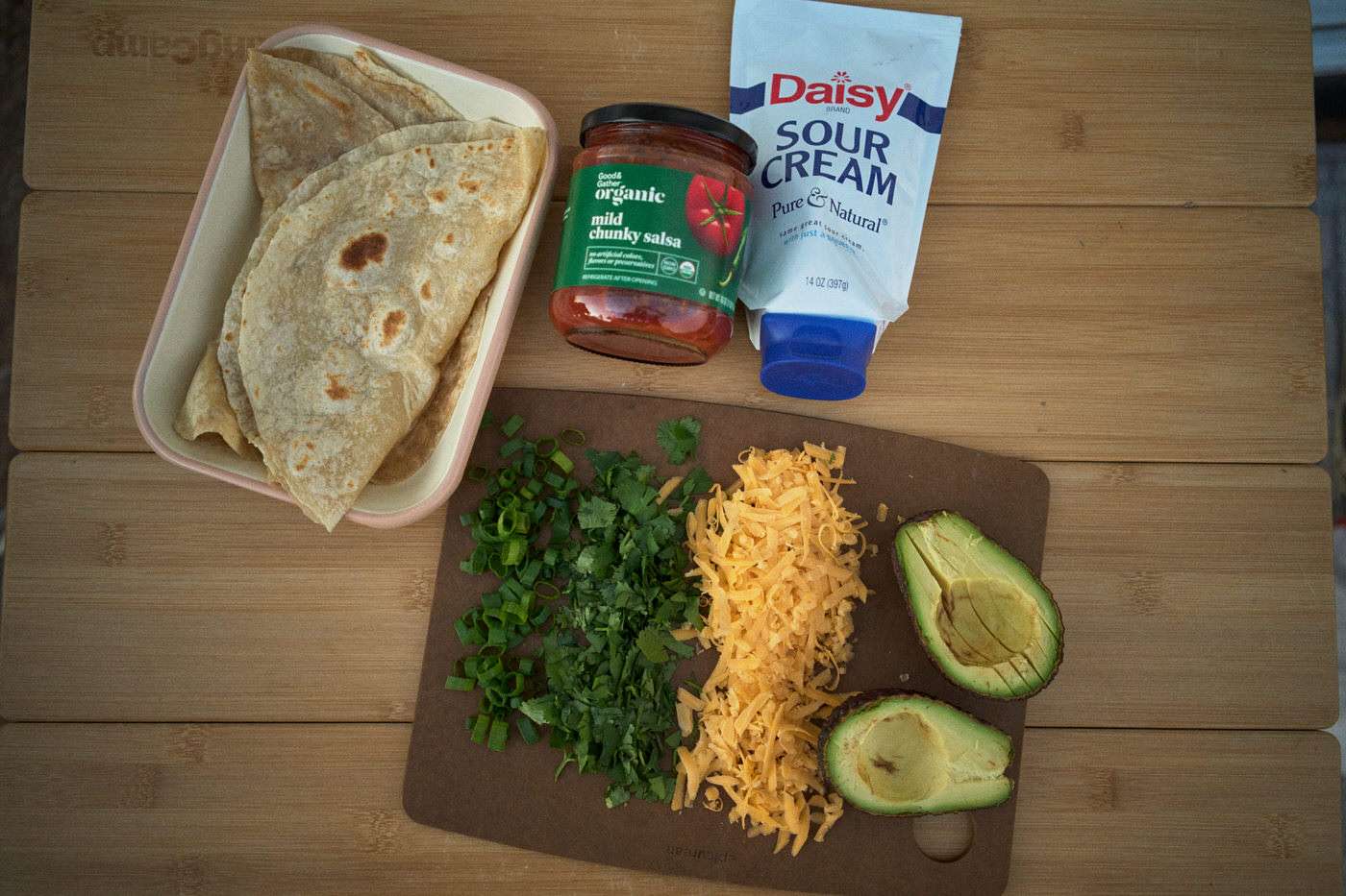 toppings and tortillas on a table for chicken fajitas