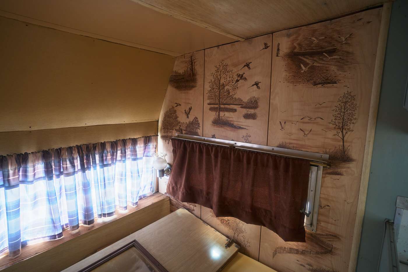 interior vintage camper wall panels before remodel 