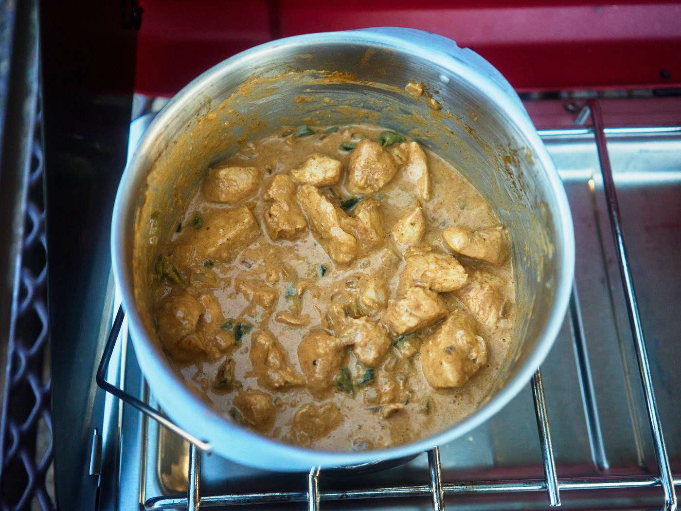 creamy salsa verde chicken in a pot while camping 