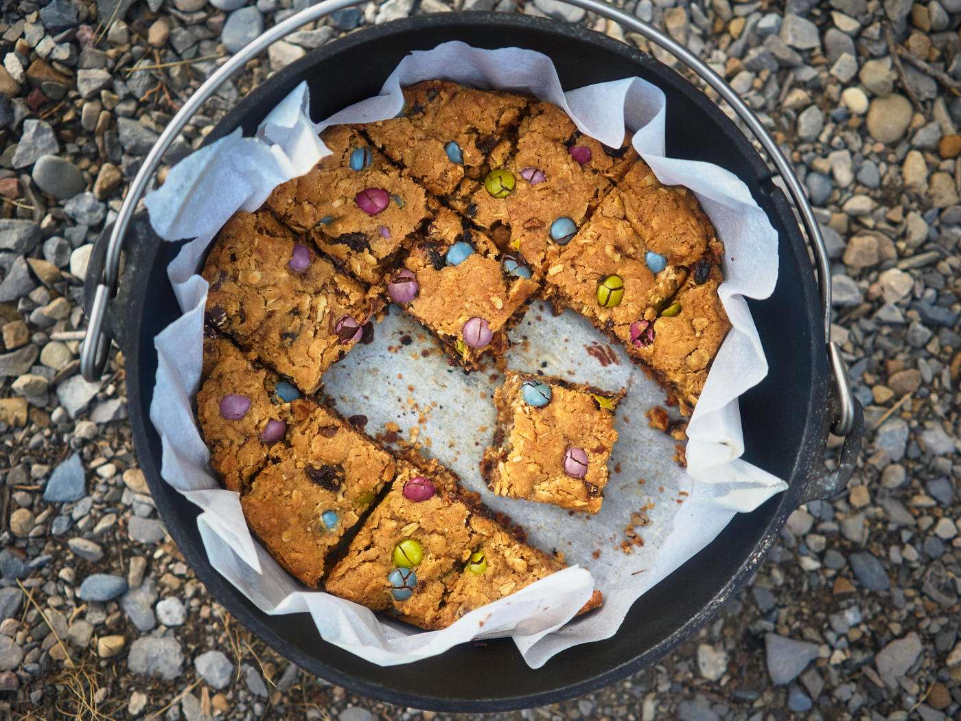 close up of trail mix cookie bars camping dessert in a dutch oven