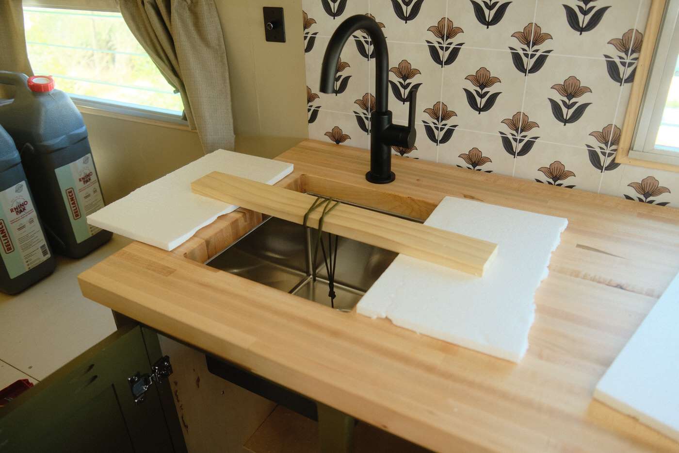 Installing the faucet and sink inside our 1960s vintage camper renovation