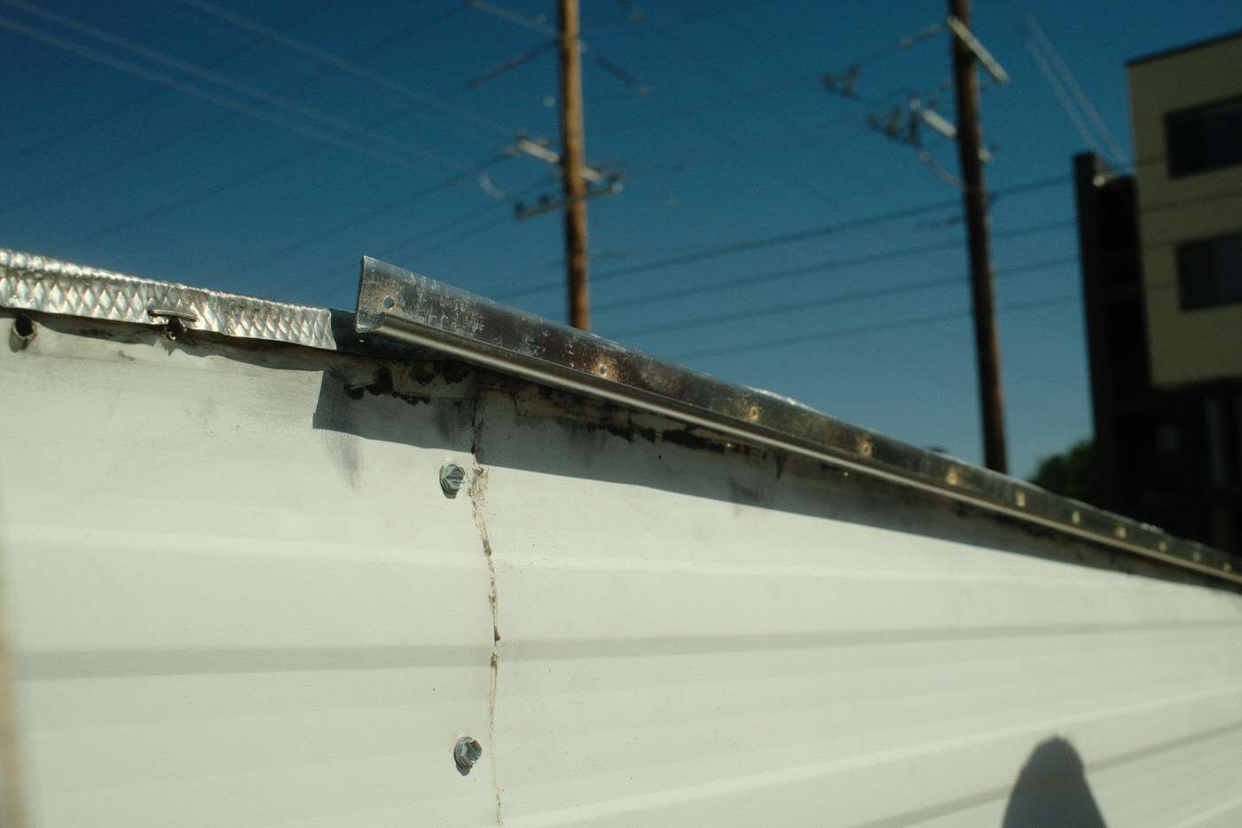 installing new j-gutter on vintage camper exterior 