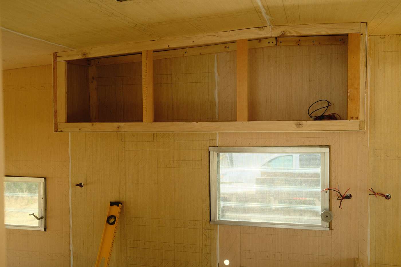 The base of the new kitchen cabinets in a vintage camper remodel