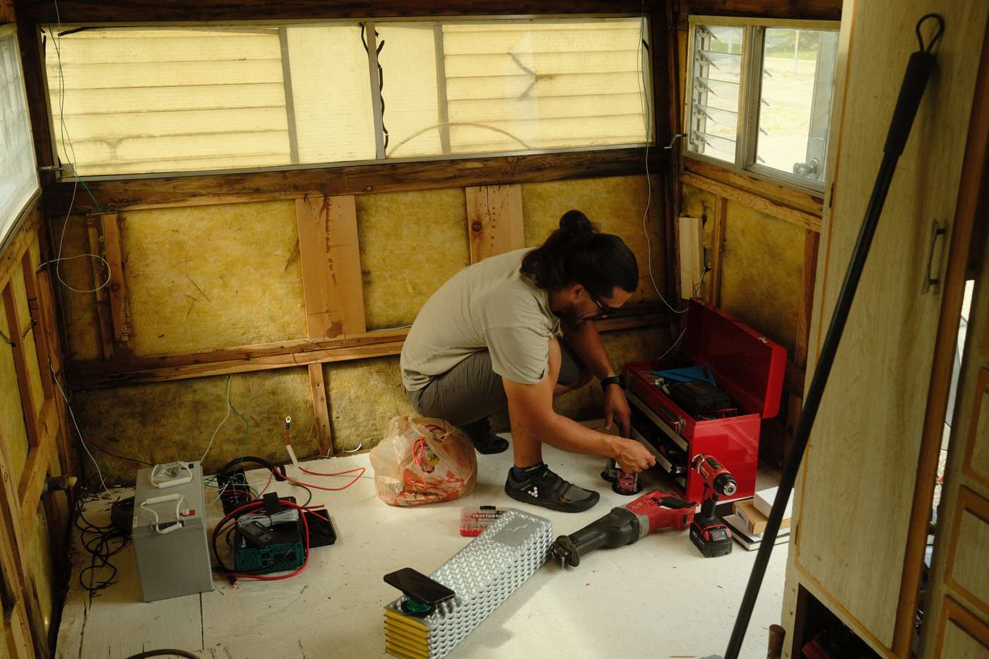 Nick working in the camper to install a new off grid electrical system 