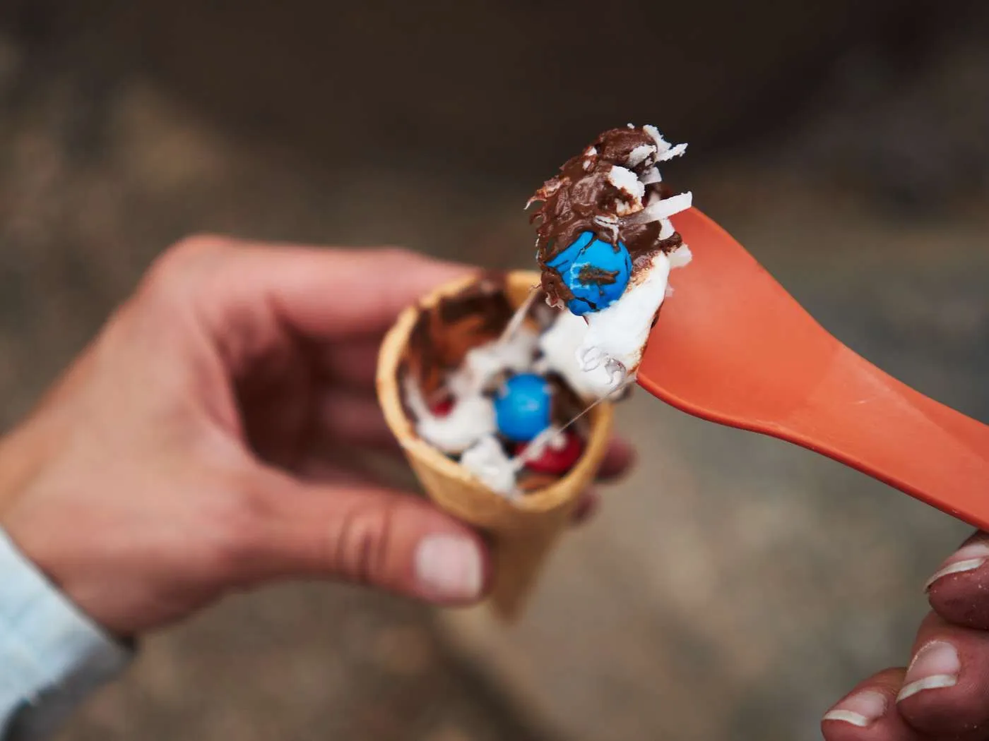Melted chocolate and marshmallow campfire cones served as an easy camping dessert