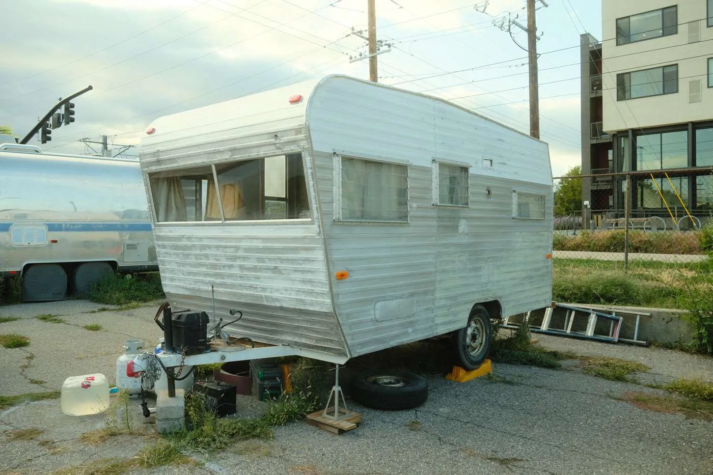 Sanded exterior of a 1960s small camper during remodel